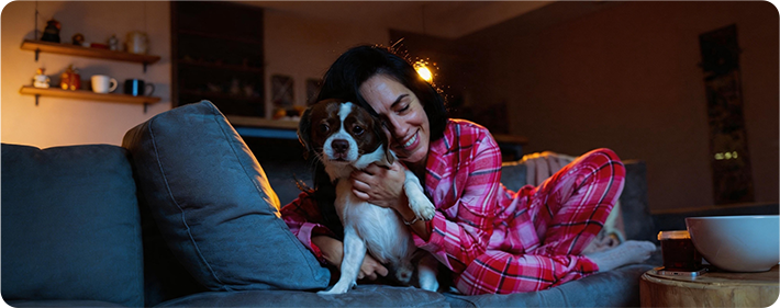 Color night vision view of a woman holding a dog