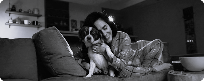 ss Black-and-white infrared night vision view of a woman holding a dog