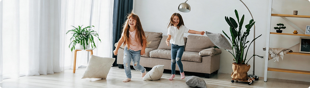 Children playing in a living room monitored by the camera